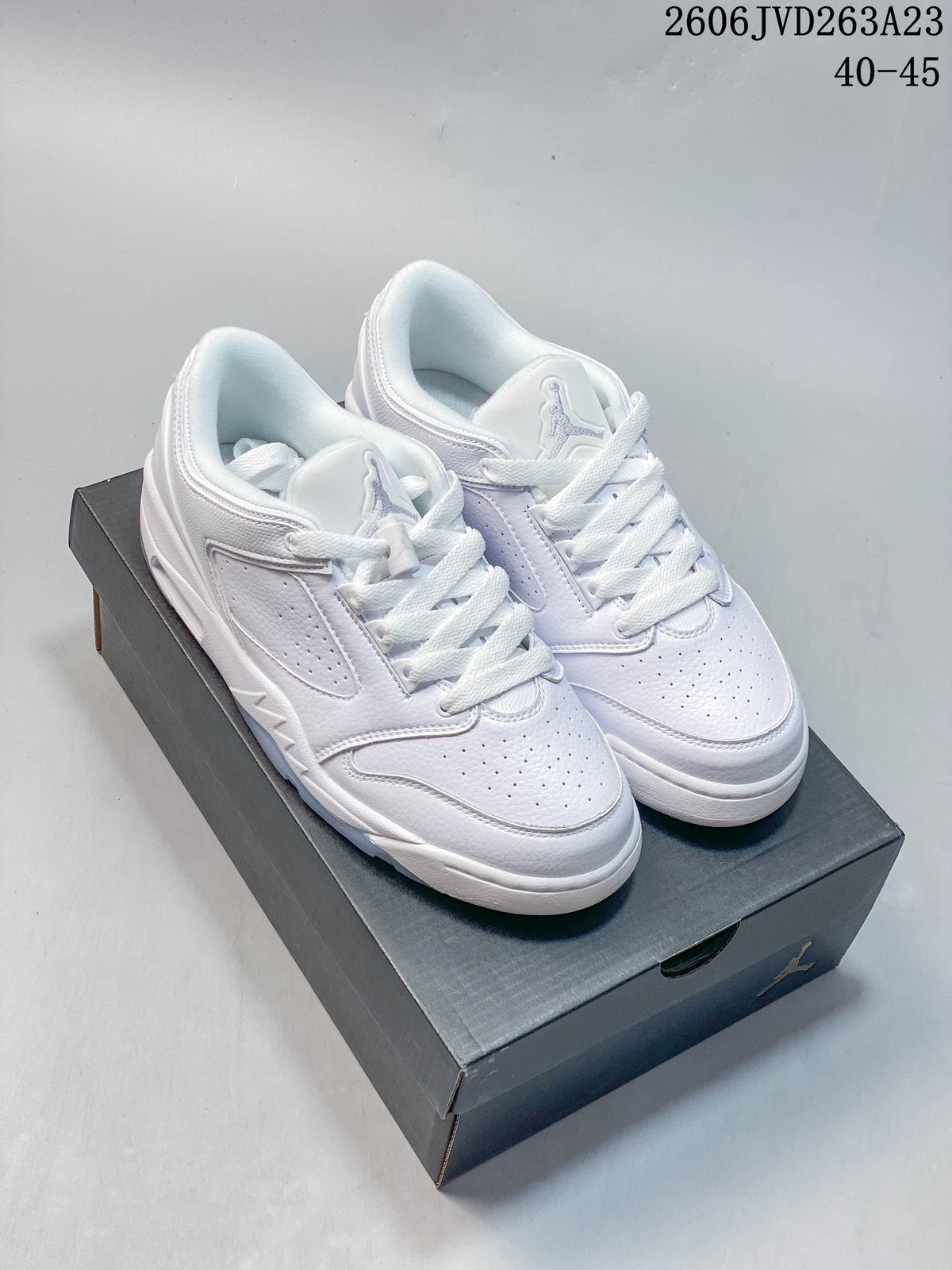 Pair of white Jordan Sixty Plus Low sneakers shown on a shoebox