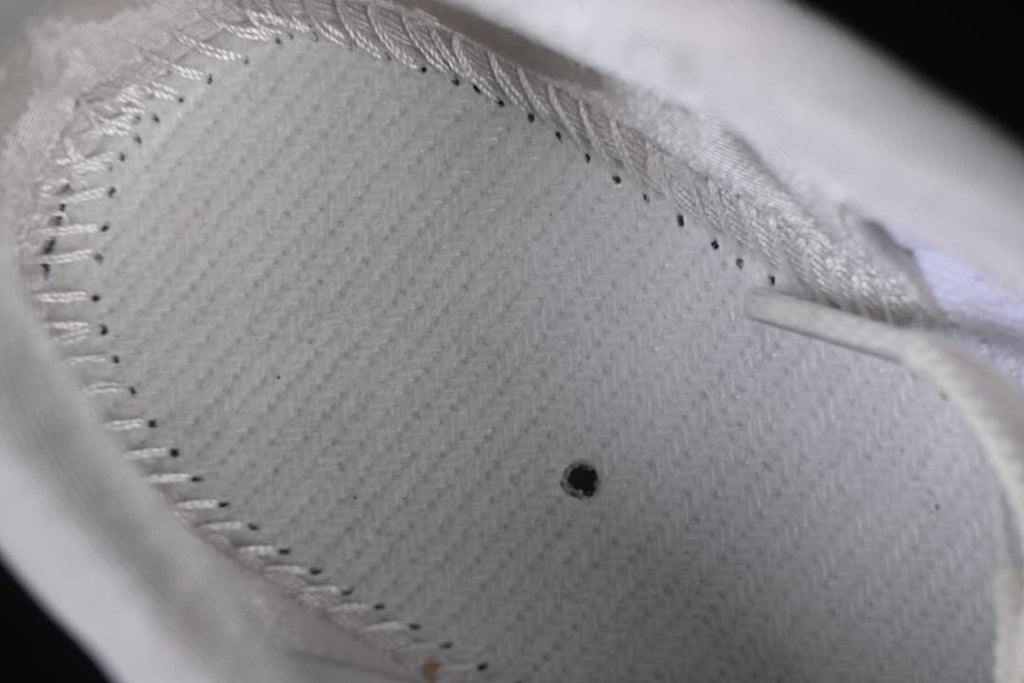 Close-up of the light-colored interior lining and stitching.