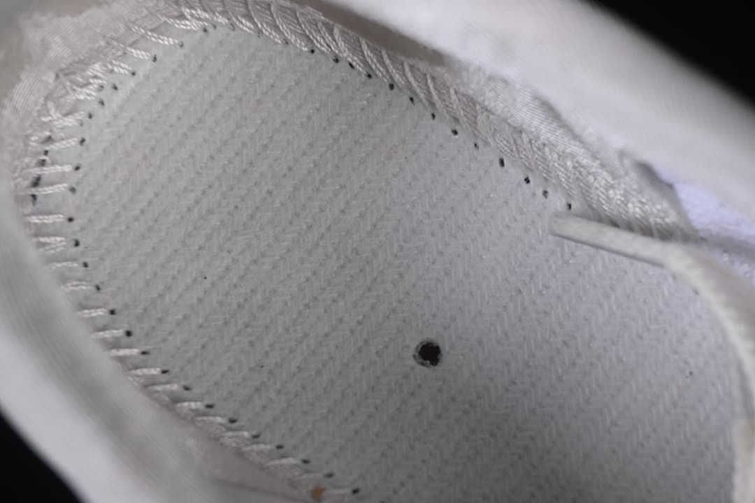 Close-up of the light-colored interior lining and stitching.