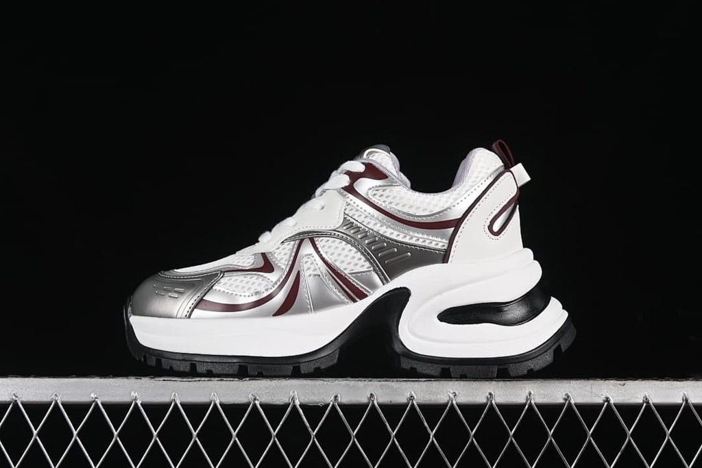 Side view of a single white, silver, and burgundy sneaker