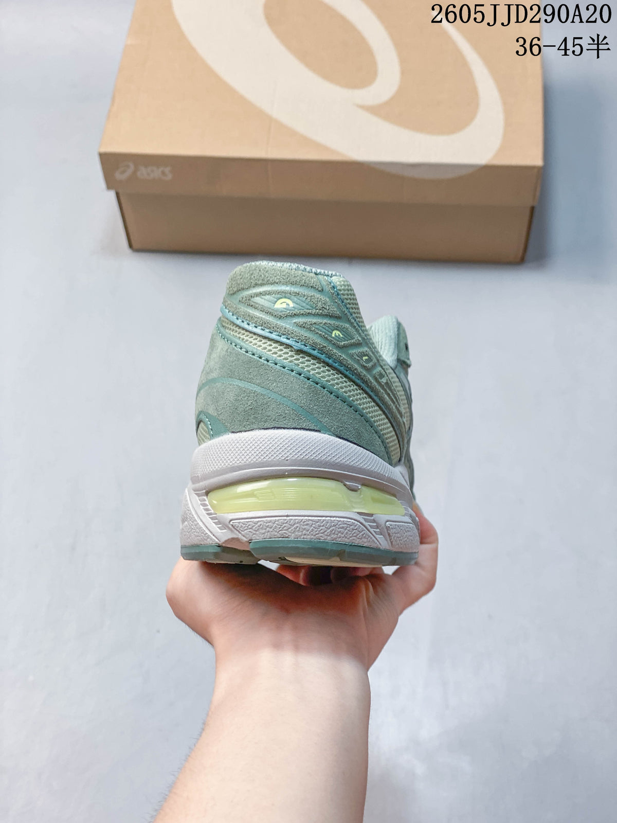 Rear view showing the heel and sole of a sage-green ASICS GEL-1130