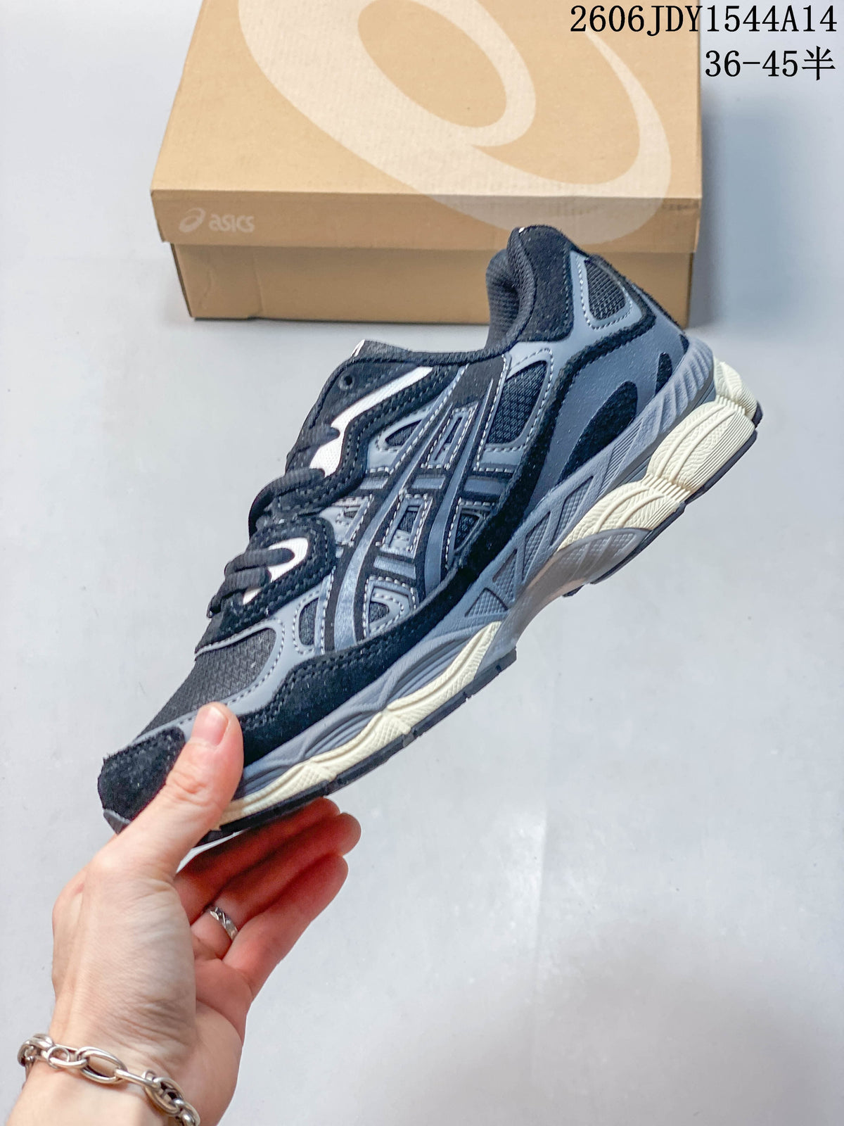 Side profile of the navy and gray sneaker with layered panels and sculpted midsole