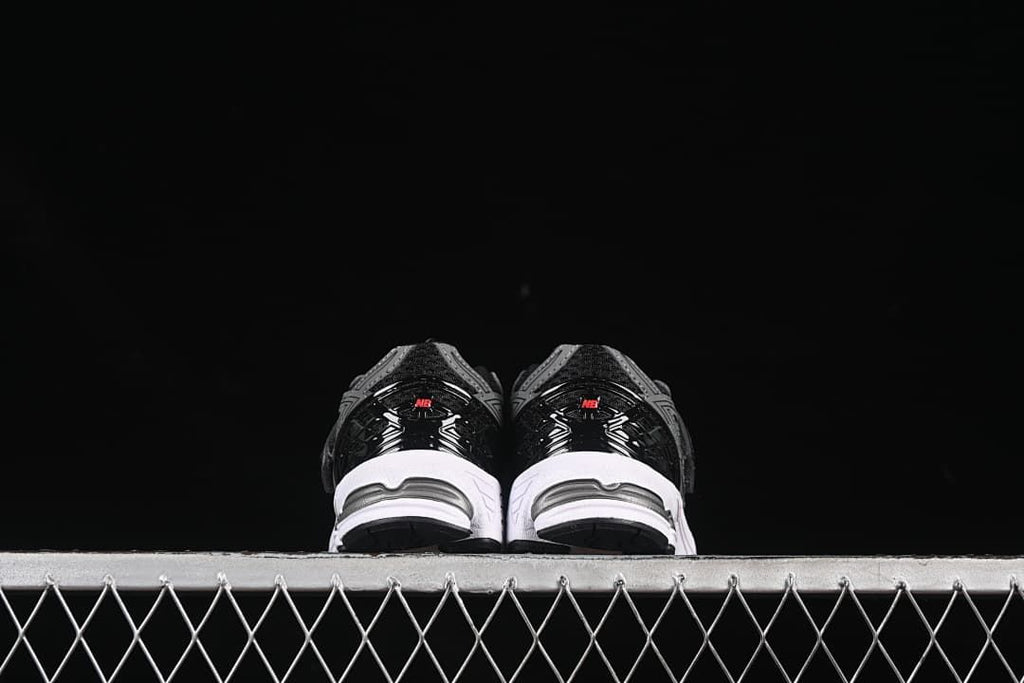 Rear view of the pair showing black heel details and white midsoles.