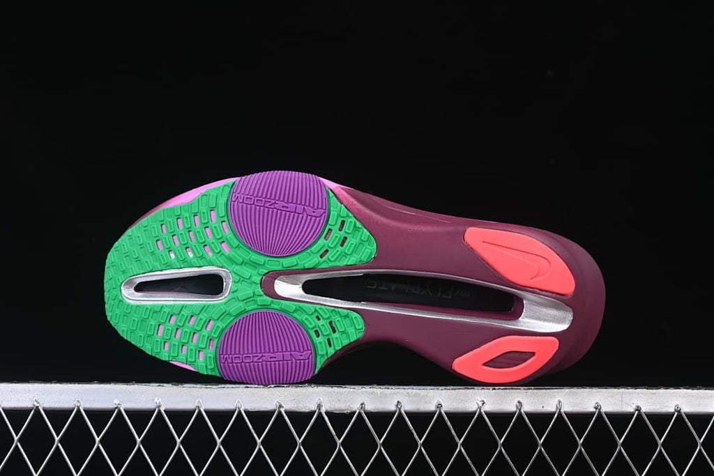 Underside view showing the shoe outsole and colored tread sections