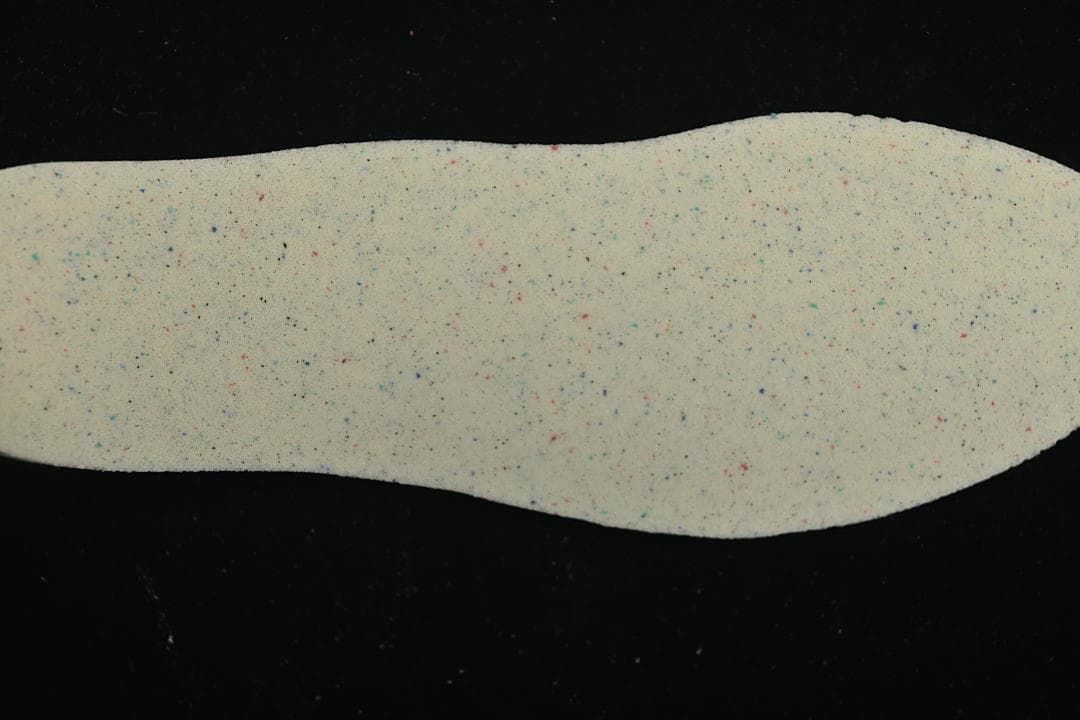 Light-colored insole shown against a dark background