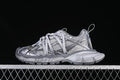 Side view of a grey mix Balenciaga 3XL sneaker against a dark background