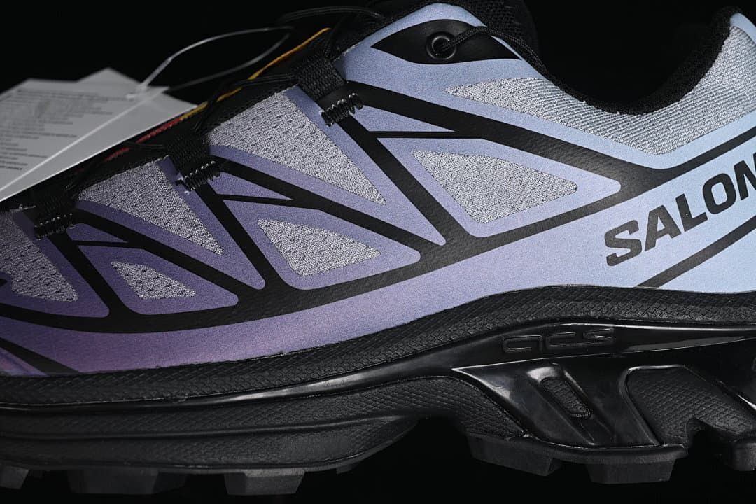 Close-up of the gray and blue-violet side panels, black overlays, and outsole.