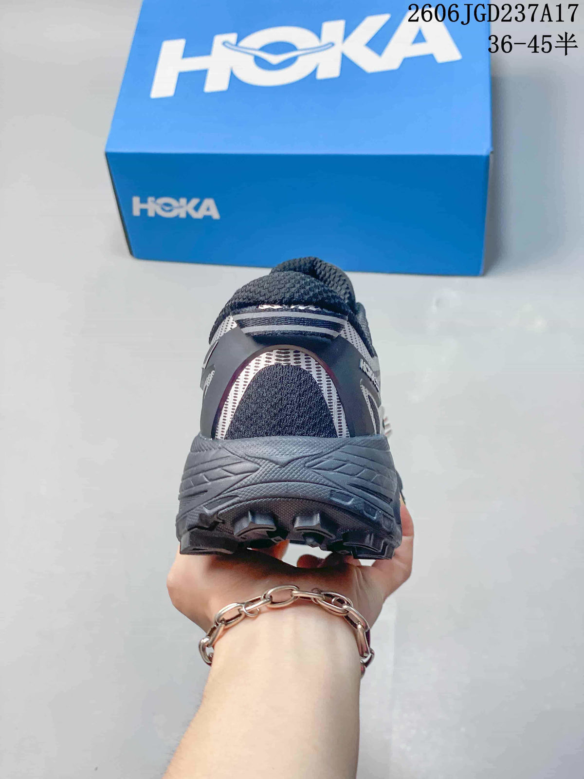 Rear view showing the heel and outsole of a silver-grey HOKA trail shoe