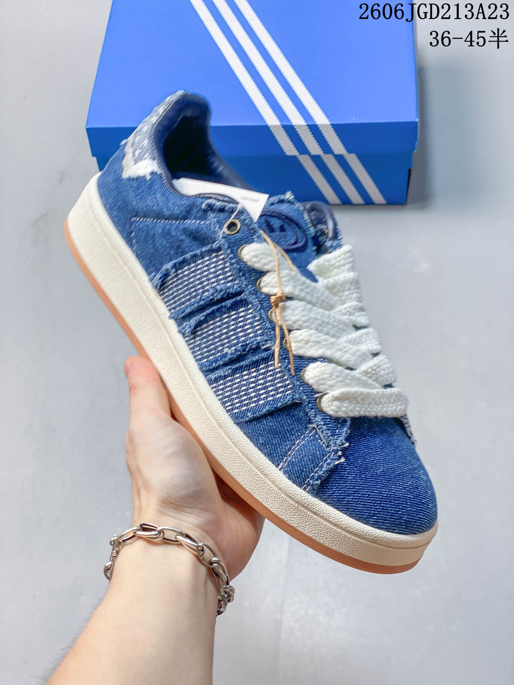 Angled side view highlighting the blue panel details, white laces, light midsole, and gum outsole.