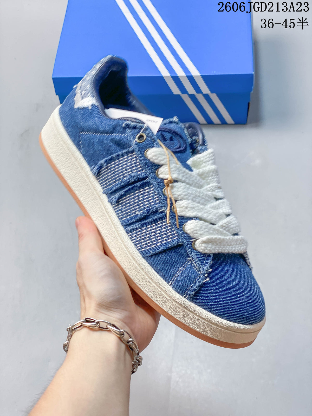 Angled side view highlighting the blue panel details, white laces, light midsole, and gum outsole.