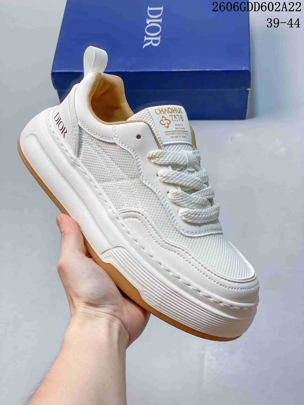 Angled view of the white sneaker with mesh panels and gum-colored outsole