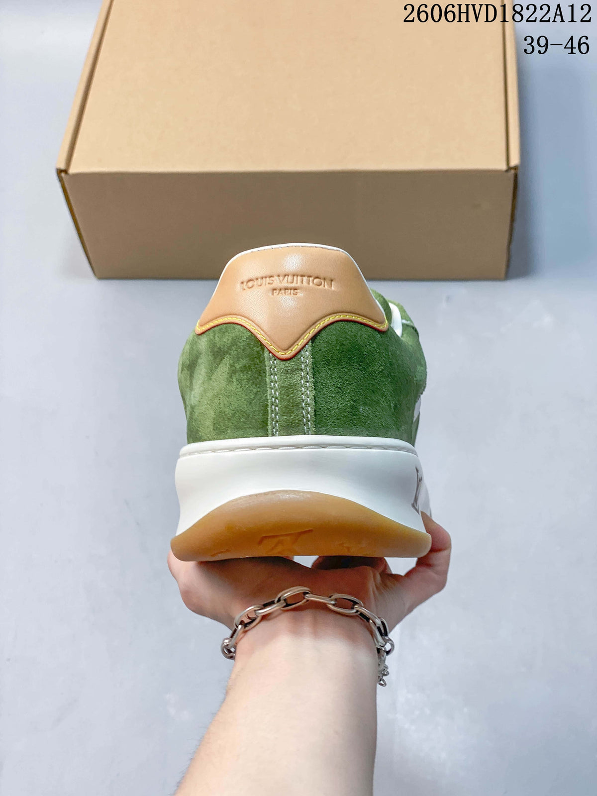Rear view of the green sneaker with tan heel detail and white midsole