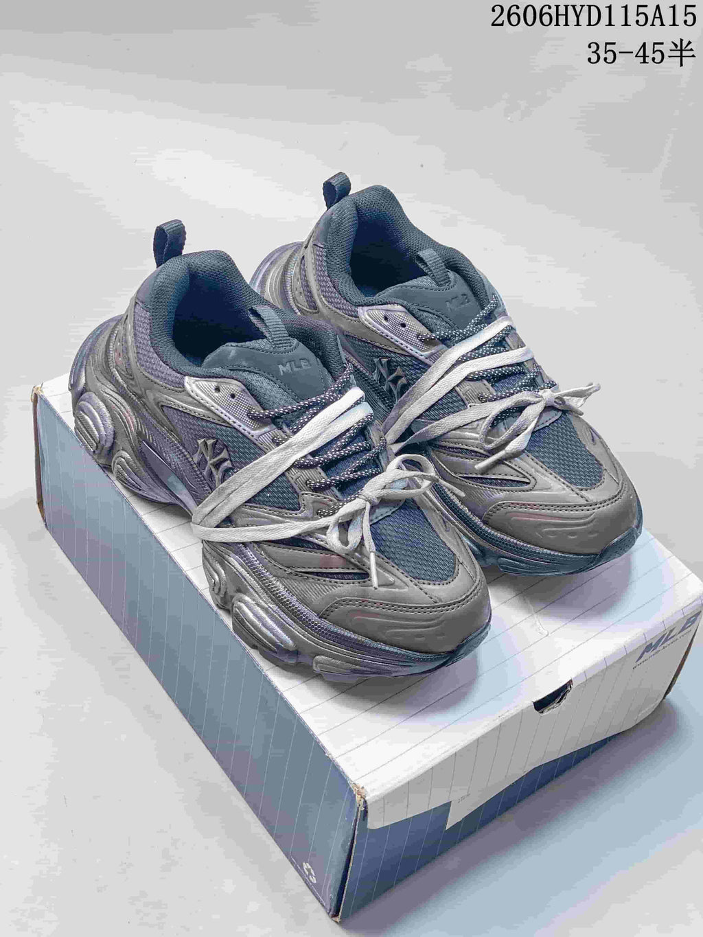 Pair of silver-gray MLB Winner Chunky low-top sneakers displayed on a shoebox