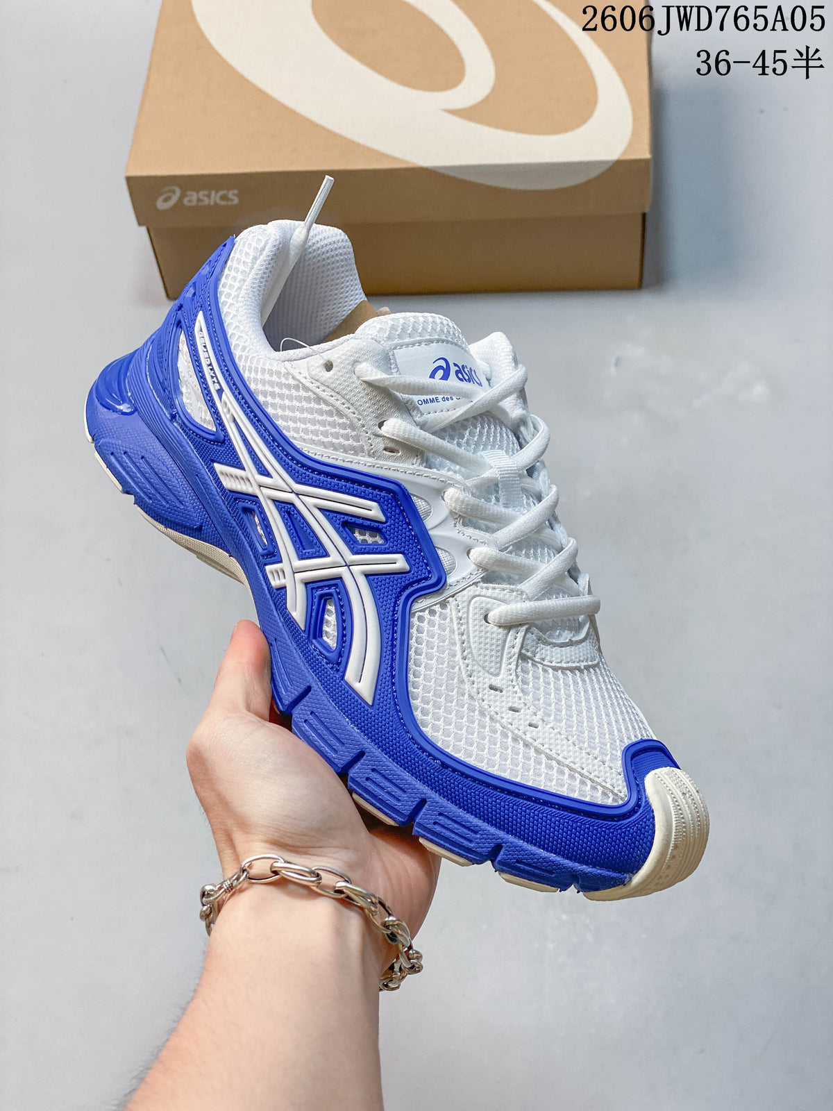 Side view of a white ASICS Gel-TRUCK sneaker with blue accents