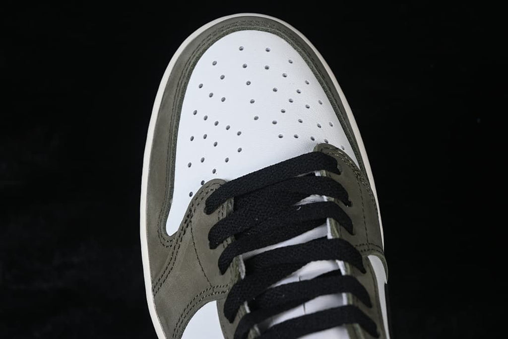 Top view of the perforated white toe box and laces