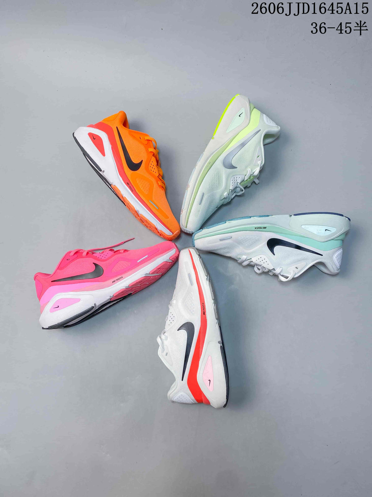Five Nike Air Structure 26 running shoes displayed in orange, lime, mint, pink, and coral-accented colorways.