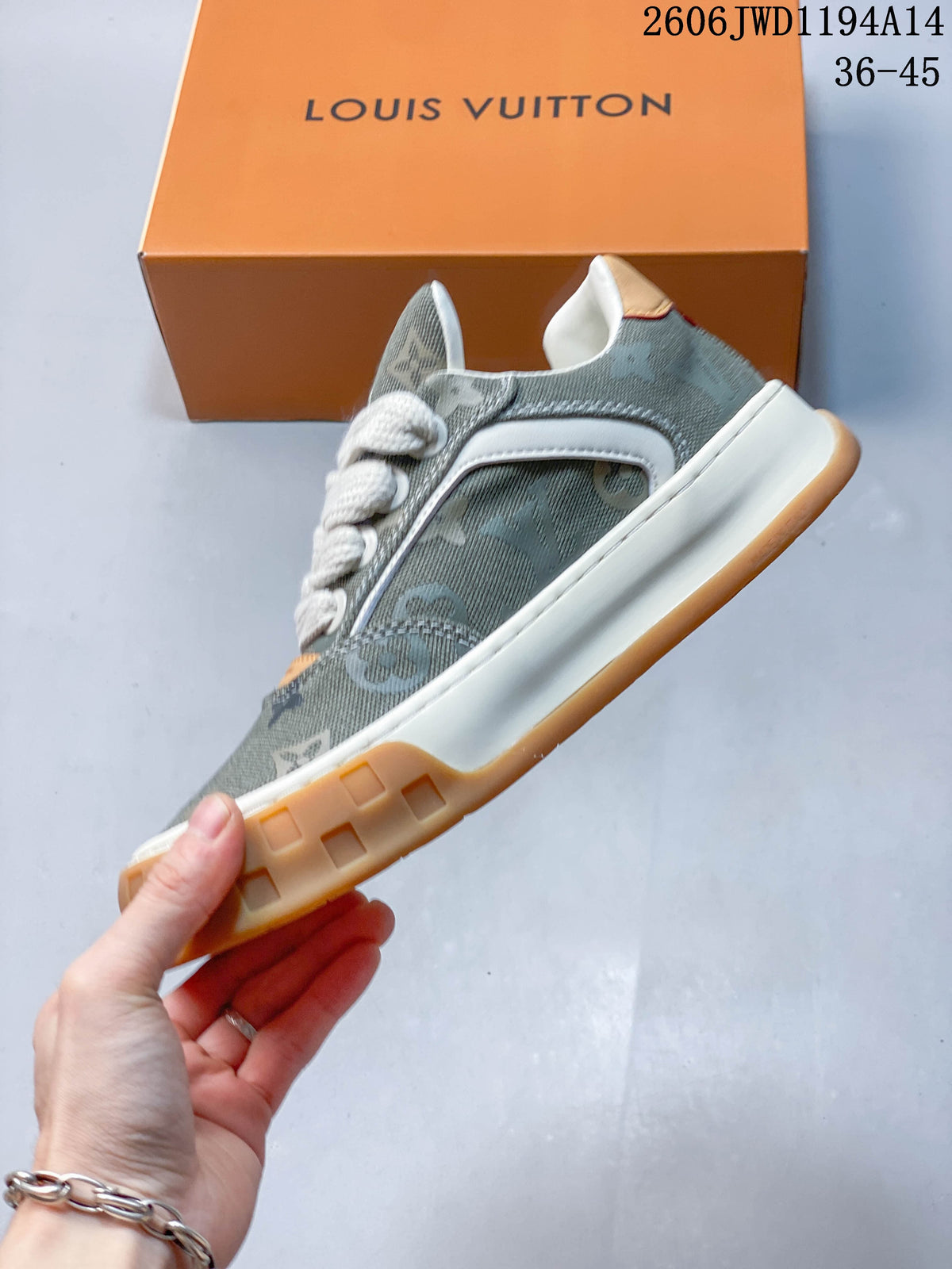 Side profile of the gray patterned lace-up sneaker with white trim and a tan-accented chunky sole.