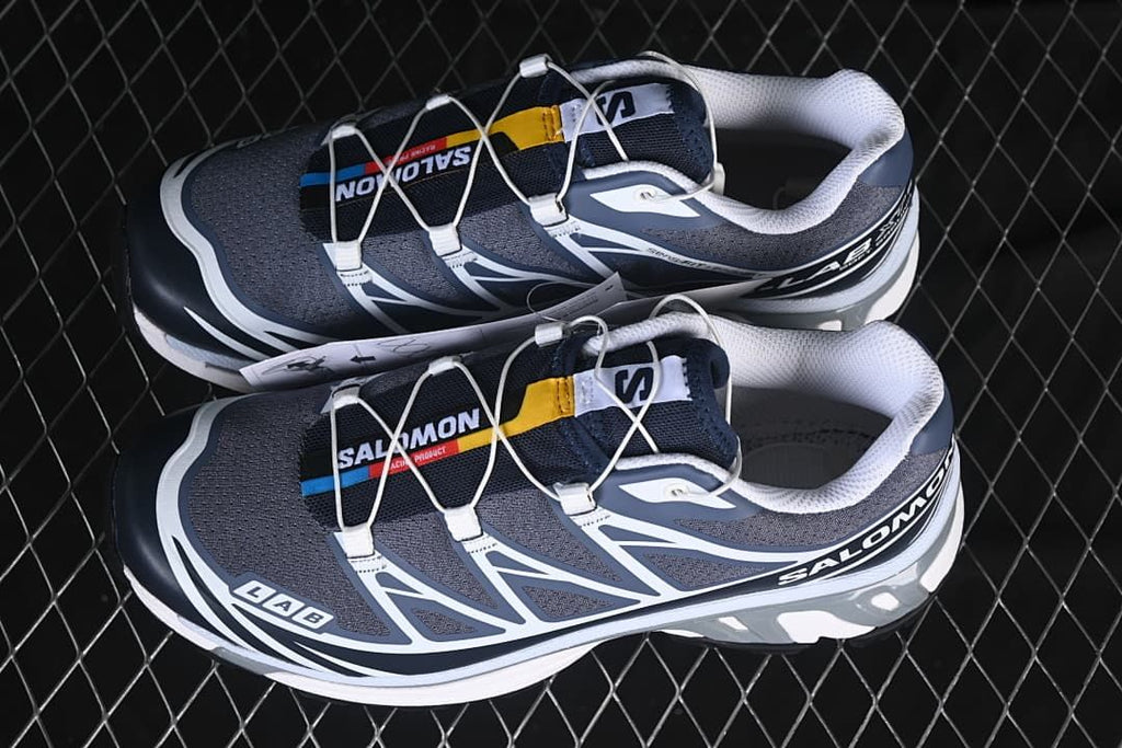 Pair of gray, navy, and white XT-6 shoes.