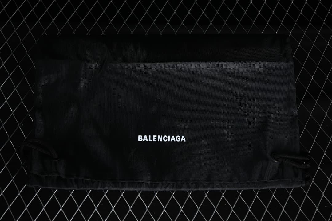 Black branded shoe dust bag shown against a dark background