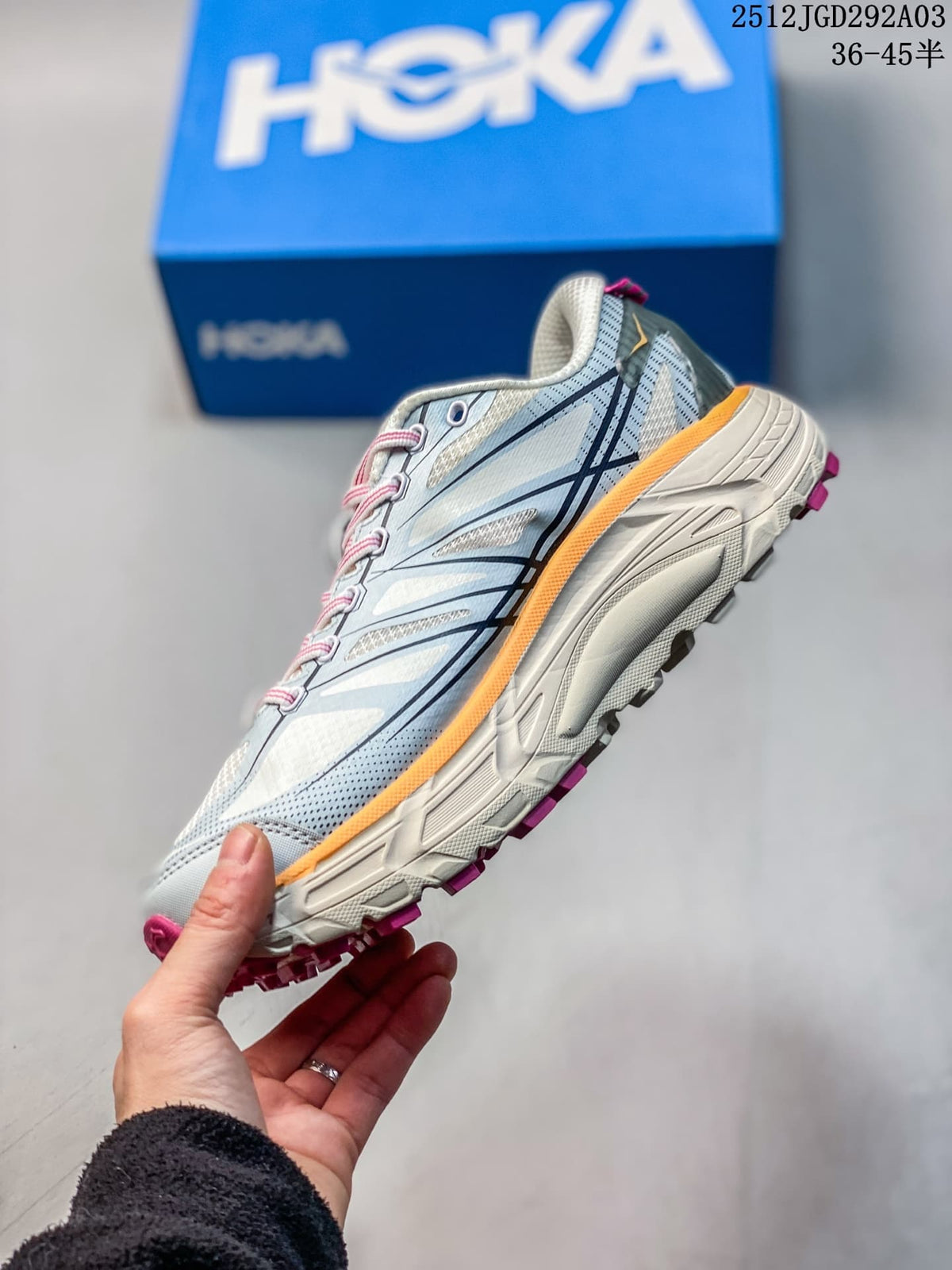 Side view of a light blue HOKA Mafate Speed 2 shoe with orange midsole trim and lugged outsole.