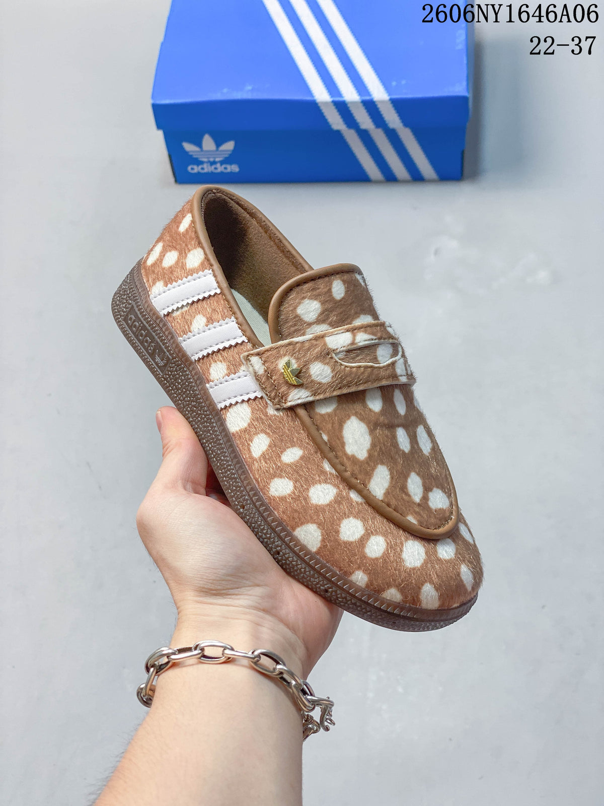 Angled view of the spotted slip-on shoe with white side stripes