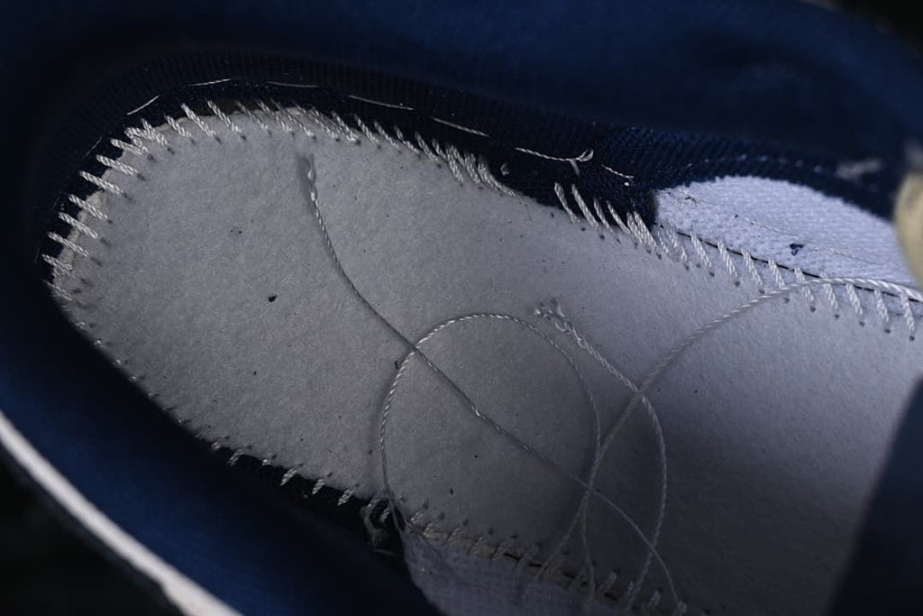 Close-up of stitching and inner construction beneath the upper