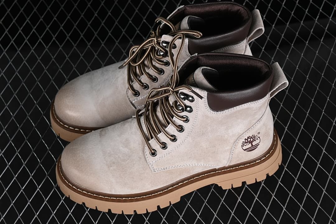 Pair of beige-grey mid-height lace-up boots shown from above and side