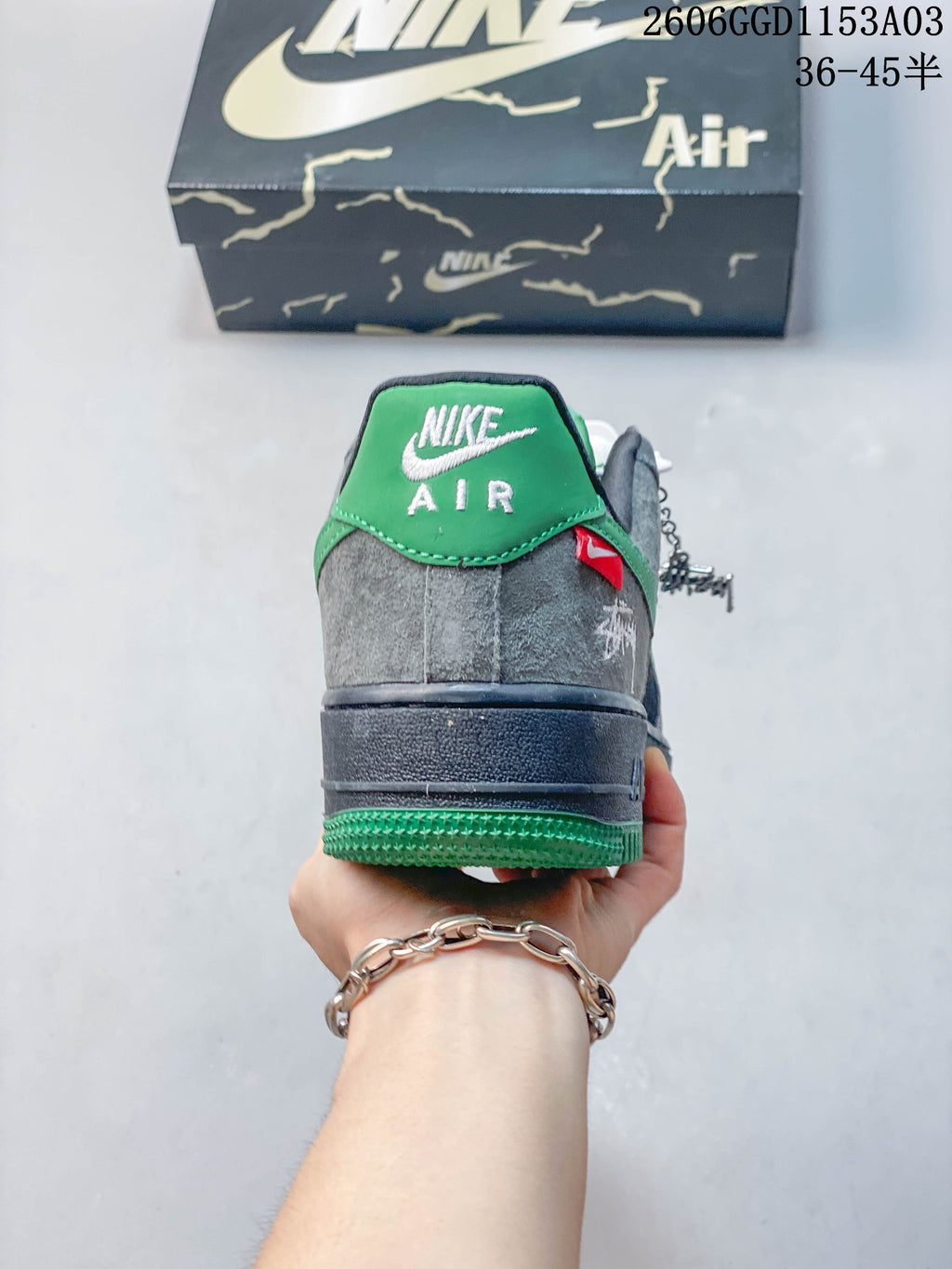 Rear view of the Nike Air Force 1 sneakers with green heel accents