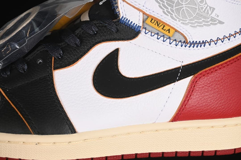 Close-up of the black Swoosh, white side panel, and ankle stitching