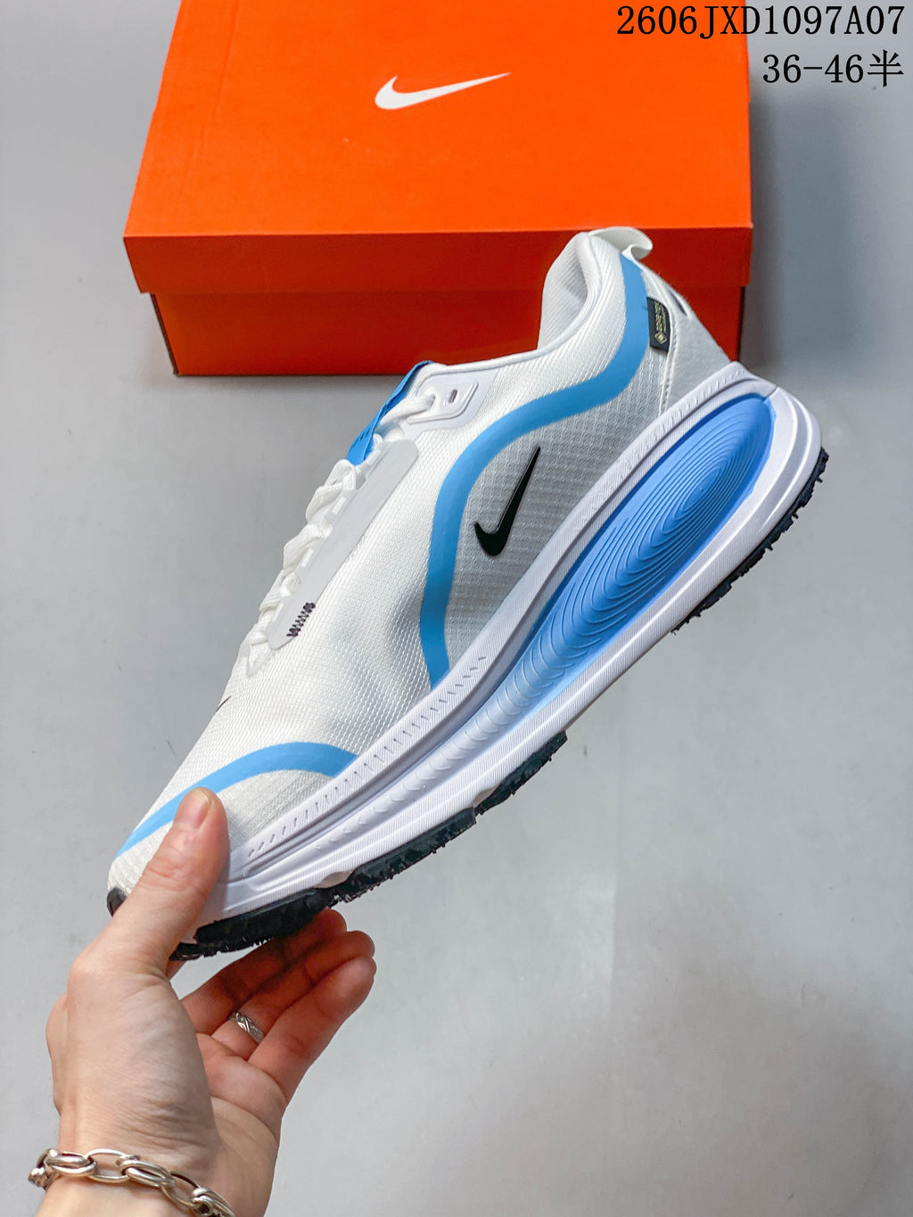 Side view showing blue accents, black Swoosh detail, and sculpted midsole