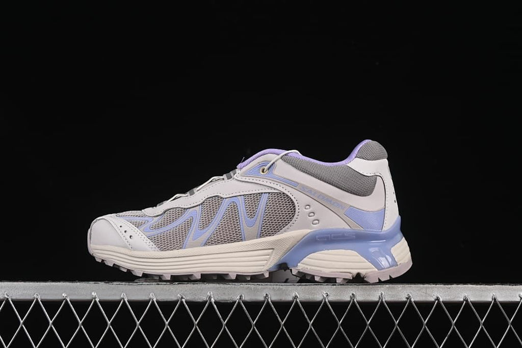 Side view of the Salomon XT-Whisper in gray, off-white, and lavender-blue.