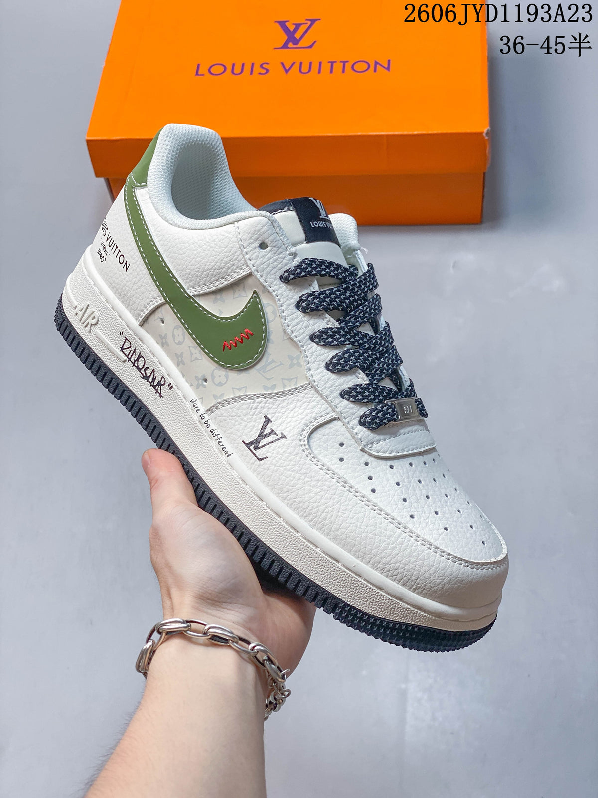 Angled view of the sneaker with a white upper, green swoosh-shaped detail, patterned side panel, and dark outsole.