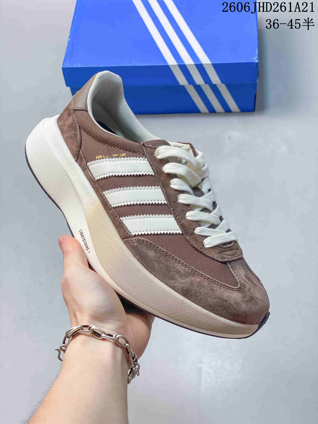 Side view of the SL 72 sneaker with taupe-toned panels and white stripes