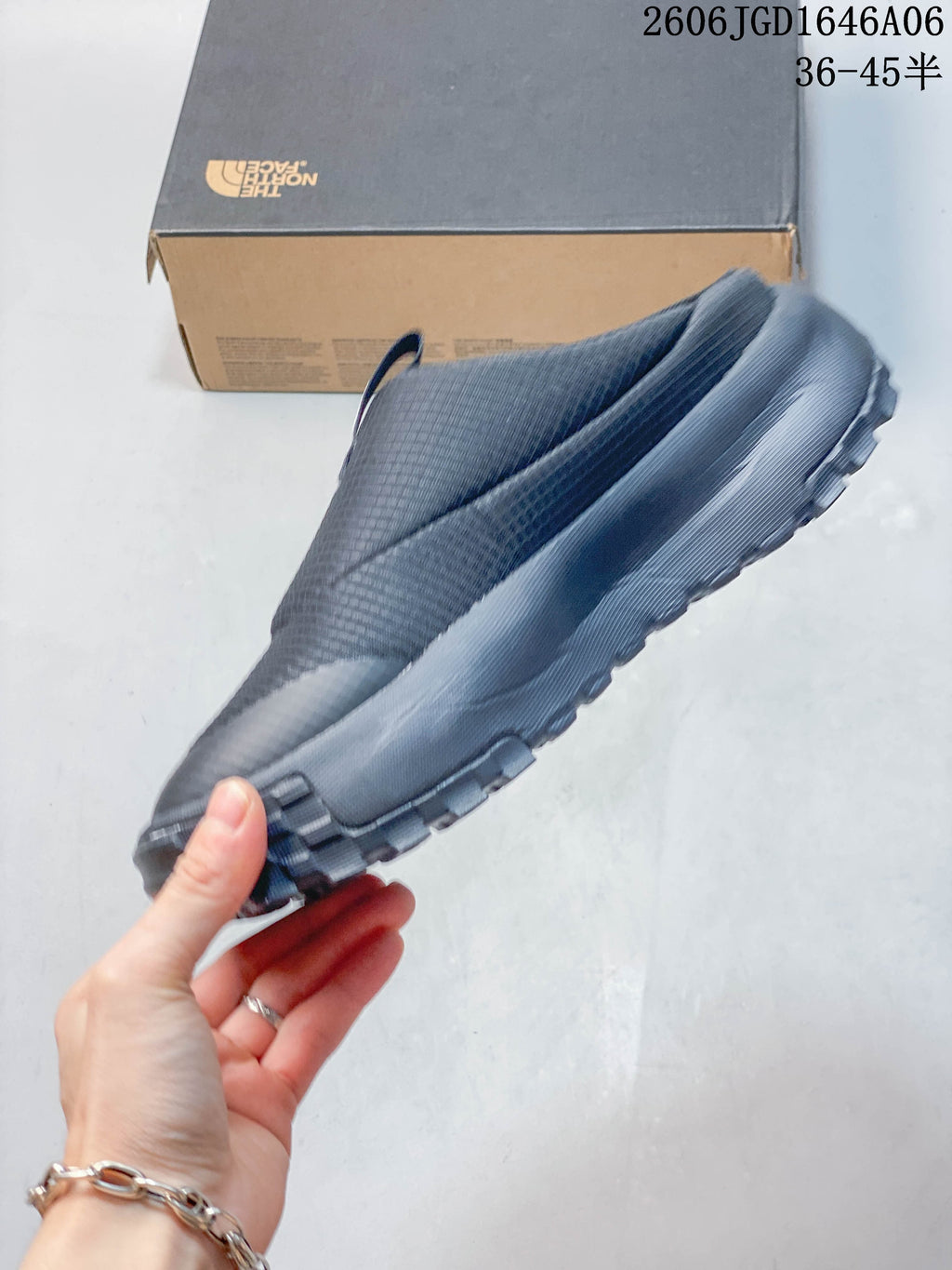 Side profile of a charcoal The North Face mule shoe with a lugged sole