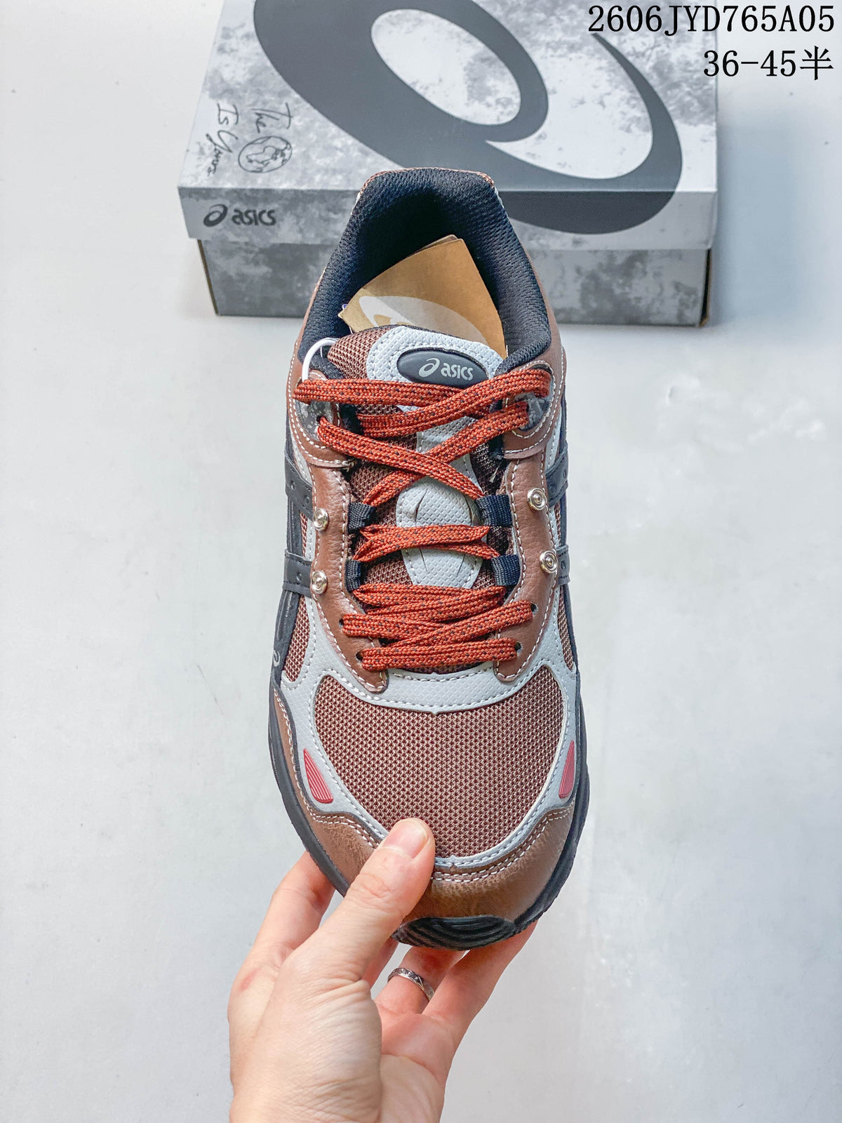 Top view of the sneaker with rust-colored laces and contrasting panels.