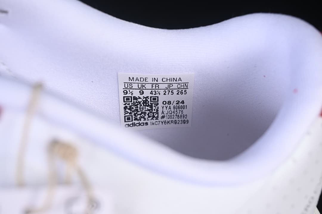 Close-up of shoe label showing US 9.5, UK 9, FR 43⅓, JP 275, and style code JQ4576