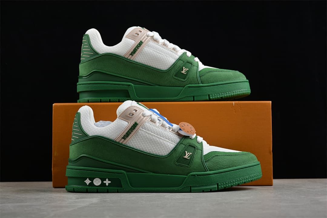 Pair of green and white sneakers displayed beside a box