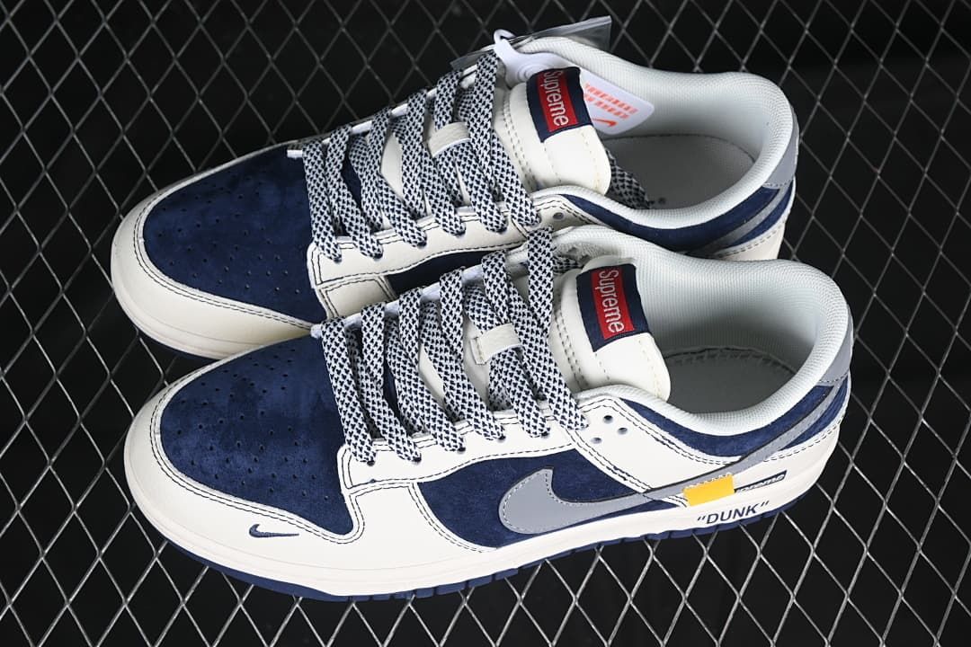Pair of navy, off-white, and gray low-top sneakers viewed from above.