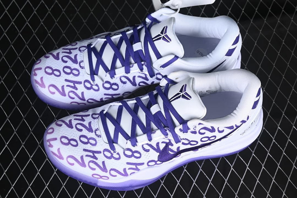 Pair of white and purple basketball shoes viewed from above