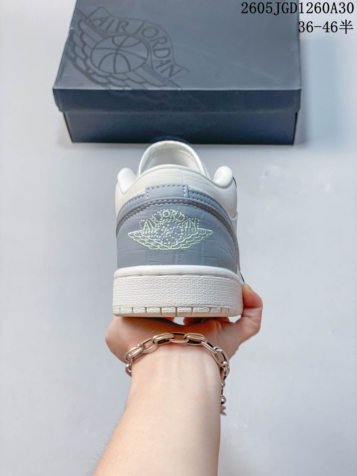 Rear view showing the gray heel panel and embroidered Jordan Wings emblem