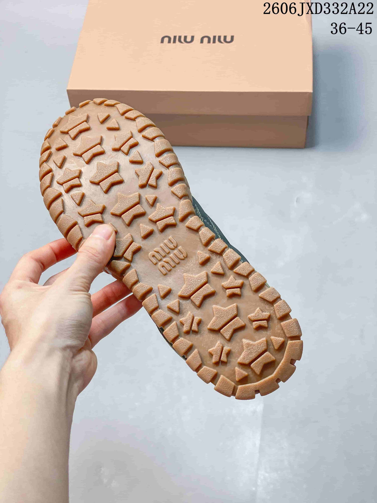 Close-up of the tan patterned outsole on a Miu Miu Tyre sneaker