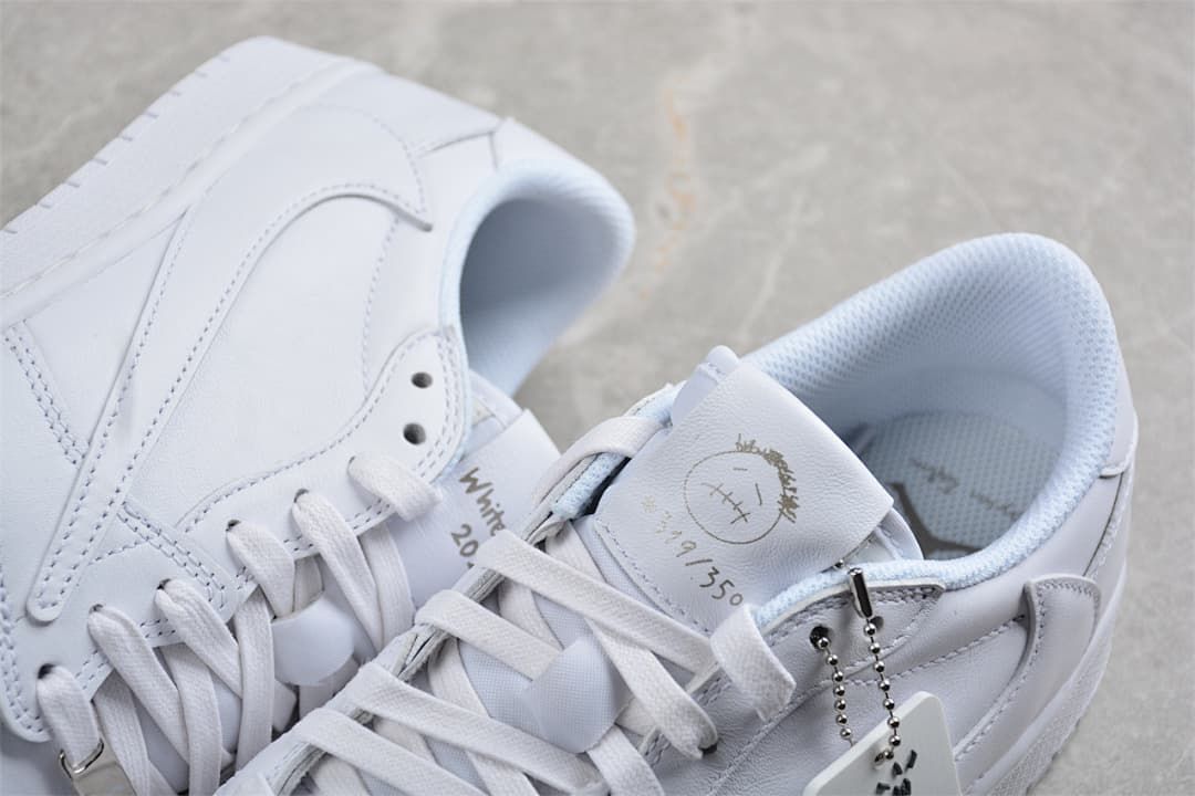 Close-up of the white sneaker tongue, laces, and decorative details