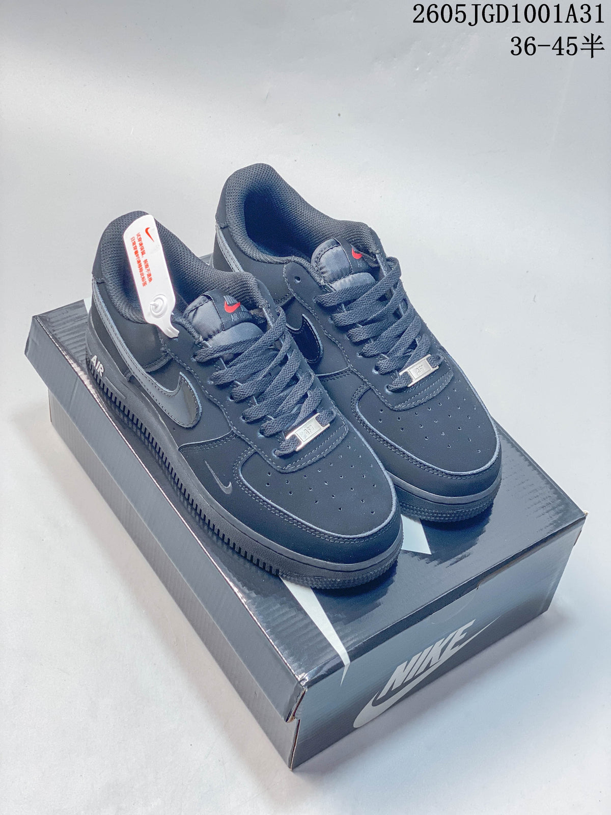 Pair of dark navy Nike Air Force 1 '07 low-top sneakers on a Nike shoe box
