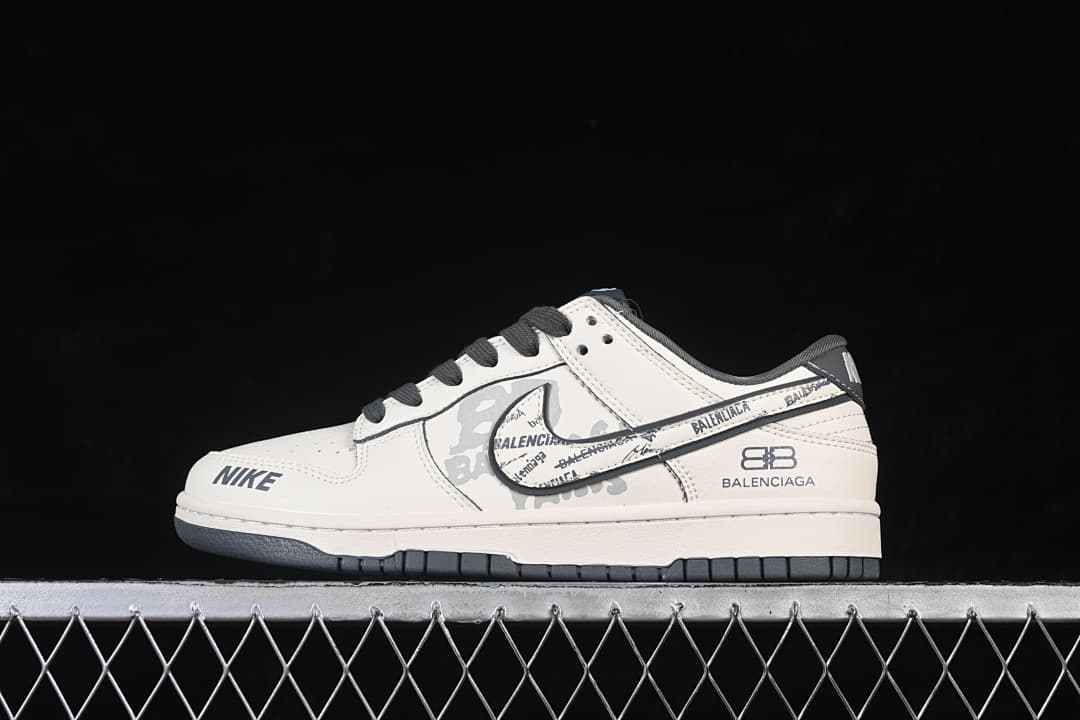 Side view of white and gray Nike SB Dunk Low shoes with black accents and printed details