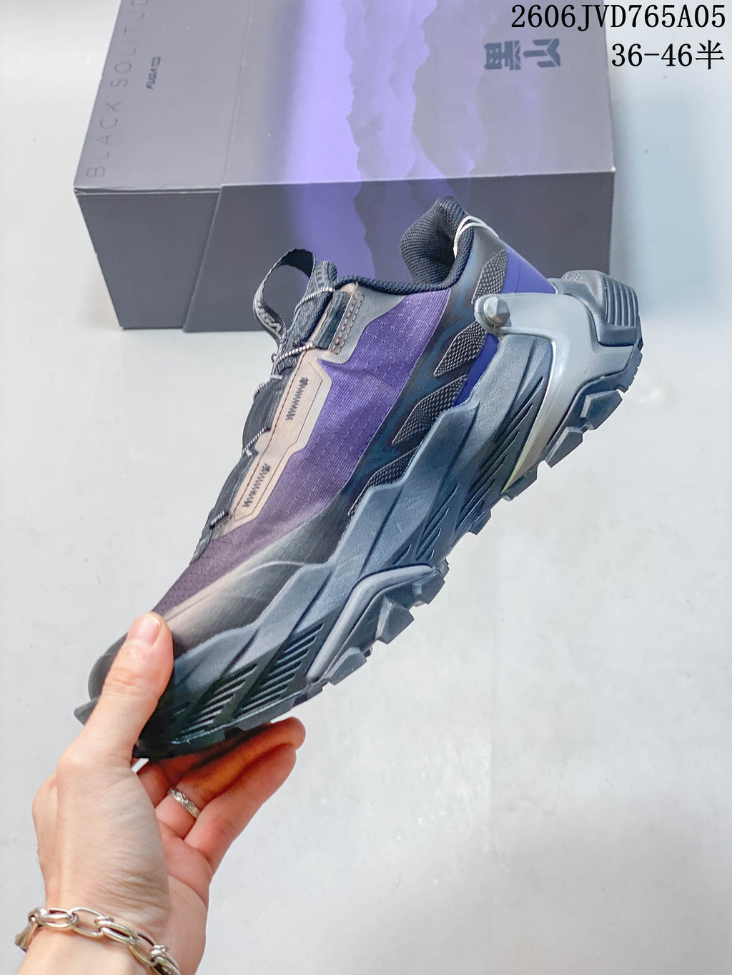 Side view of the purple and gray low-cut trail shoe