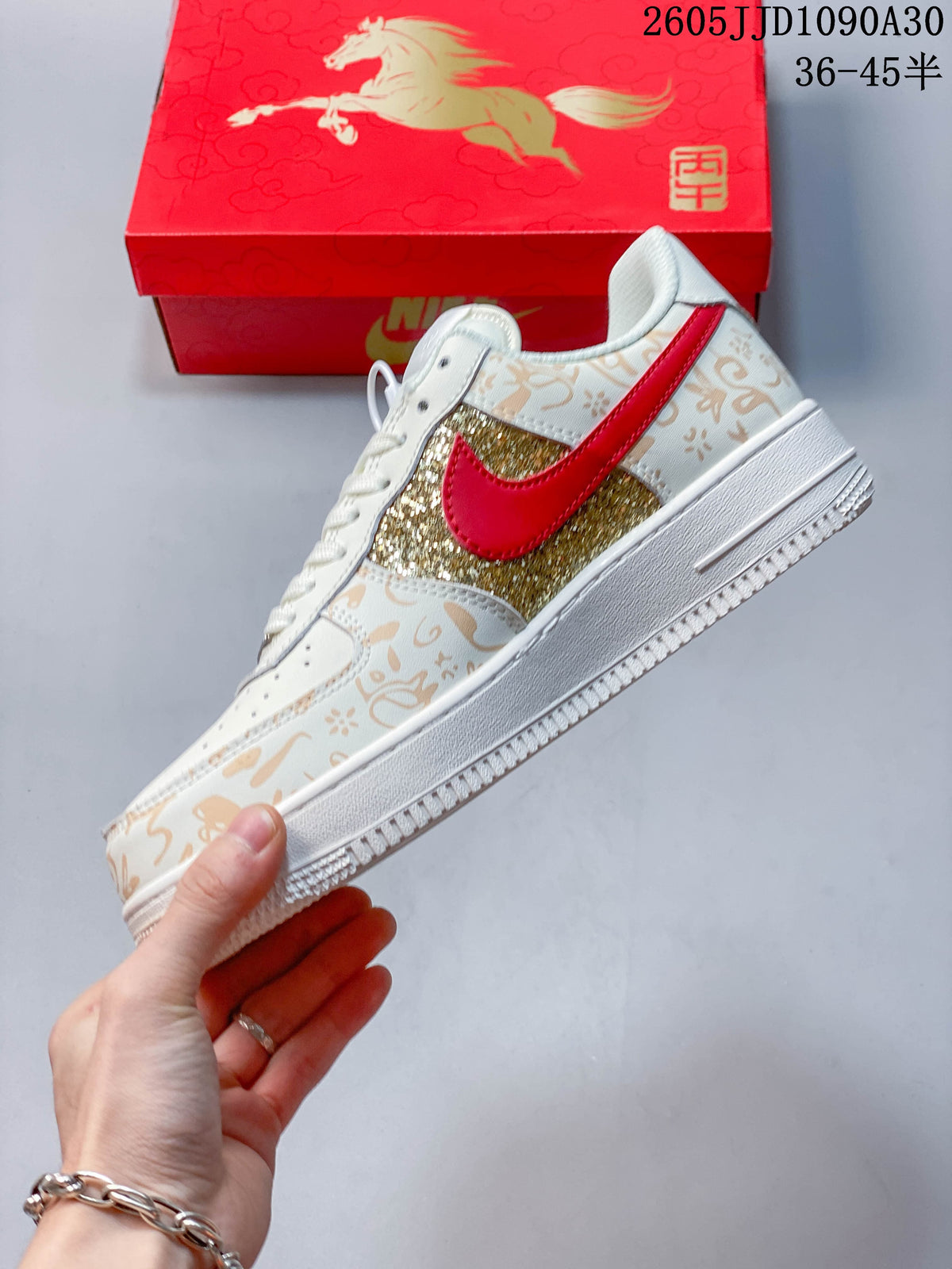 Side profile showing the gold glitter panel, red Swoosh, and tan ornamental print
