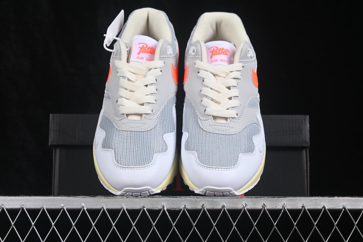 Front view of the pair showing the grey mesh toe boxes, layered white overlays and cream-colored midsoles.