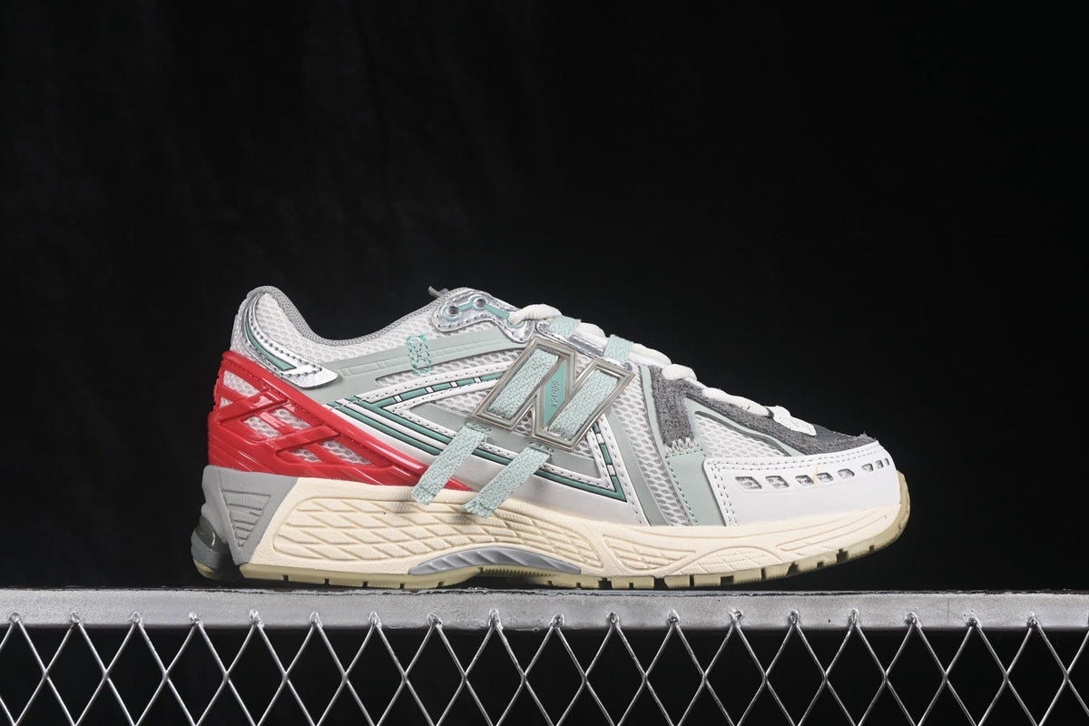 Side profile showing the layered upper, large New Balance branding and sculpted sole.