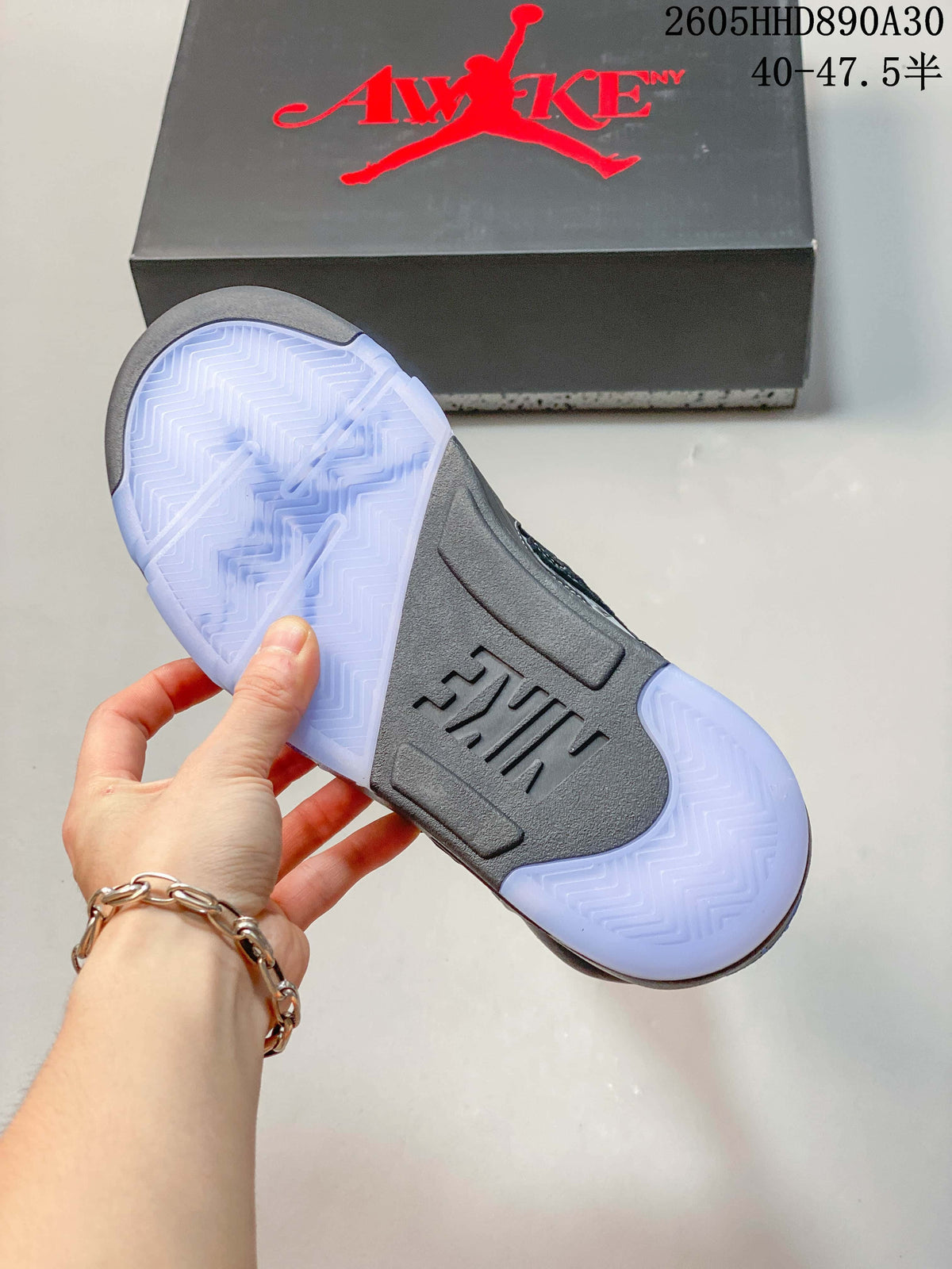 Translucent-looking outsole of the gray and blue Air Jordan 5 sneakers
