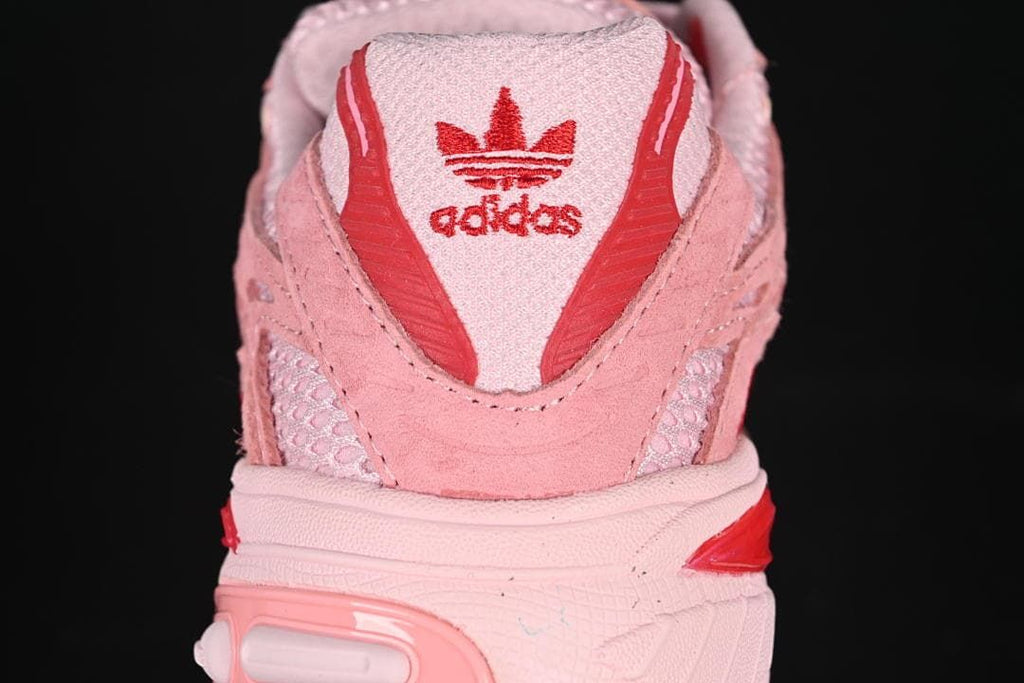 Rear view of the pink sneaker with red adidas branding.